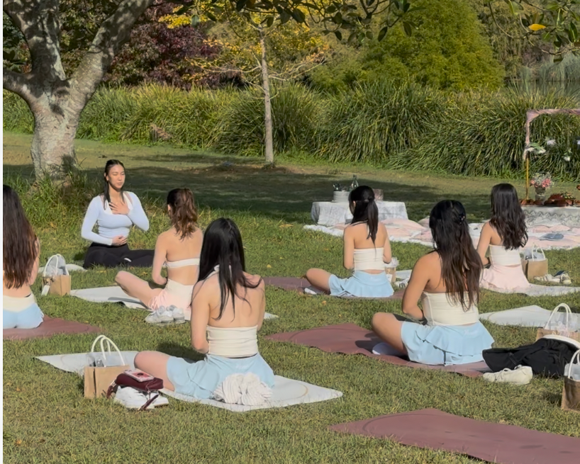 Group of women practicing yoga in a park setting